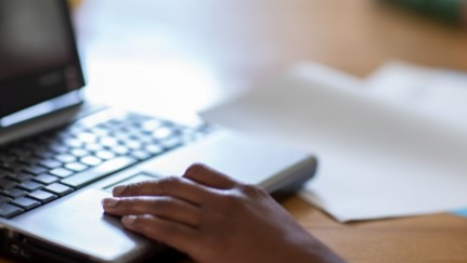 close up of a hand on a laptop