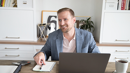 A business owner sits behind a desk.