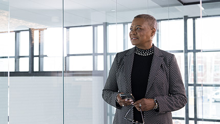 Business woman walking through commercial office space