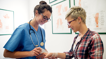 occupational medicine provider wraps employee's hand in bandage