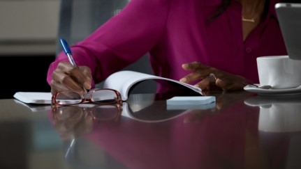 woman writing in a notepad
