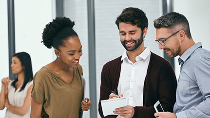 Group of interns at a table taking notes