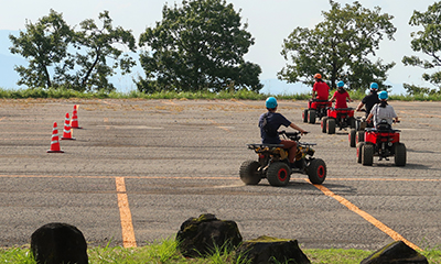 people riding ATVs on a parking lot course