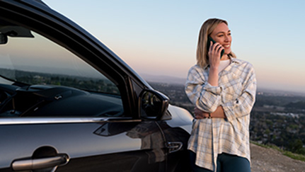 Woman standing by her vehicle