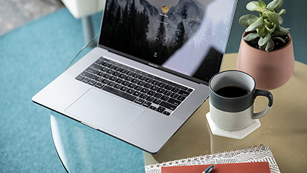 laptop and cup of coffee on a table