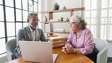woman and man sitting at a table in an office