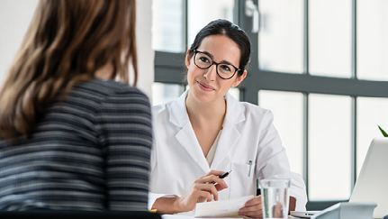 employee and doctor talking in an office