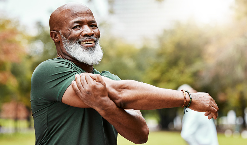 a man nearing retirement stretches before his workout