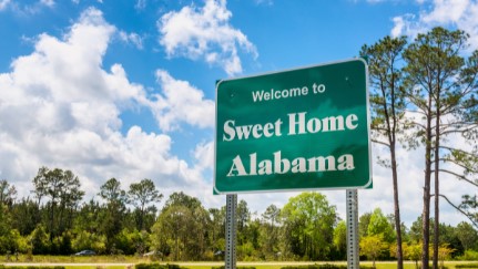 road sign reading "Welcome to Sweet Home Alabama"