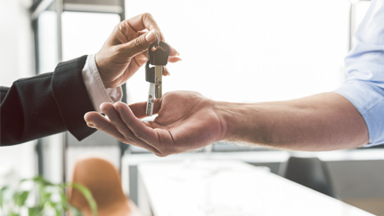 two hands exchanging car keys
