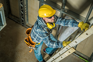 Man climbing ladder using three points of contact